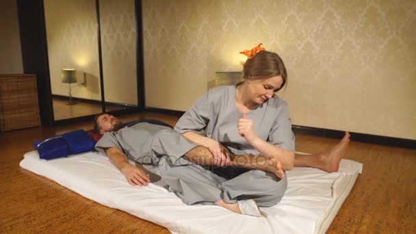 Woman making thai massage to a man — Stock Video