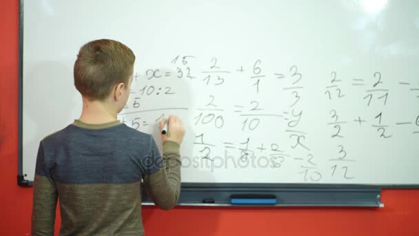 Happy schoolboy decided example on the Board — Stock Video