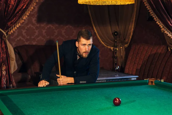 handsome serious man playing pool