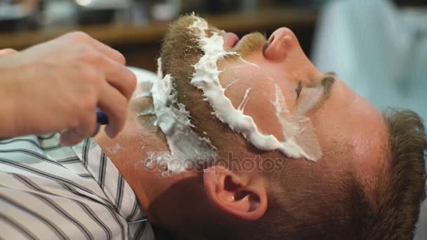 Client during beard shaving in barber shop — Stock Video