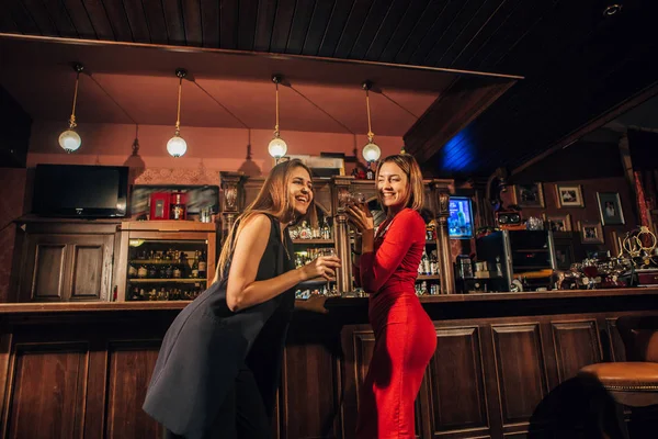 two beautiful women are relaxing in the bar