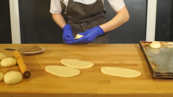 Een bakker maken van kaneel broodjes — Stockvideo
