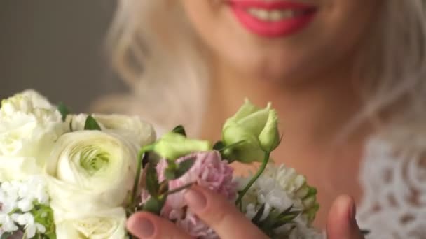 Beautiful bride smelling wedding bouquet — Stock Video