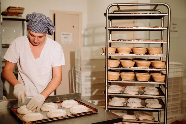 bir fırıncı ekmek hamur üzerinde el ile insizyon yapar. Bread.Bakery imalatı