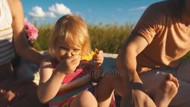 Happy little girl eating a pineapple and smiling at camera — Stock Video