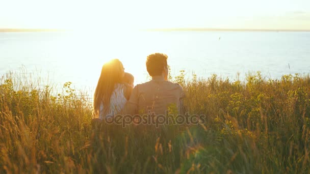 Happy family watching the sunset on the background of the river — Stock Video