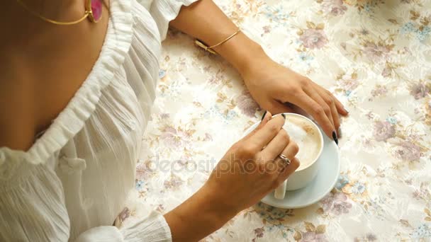 Schöne Frau in weißer Bluse, trinkt Kaffee im Restaurant — Stockvideo