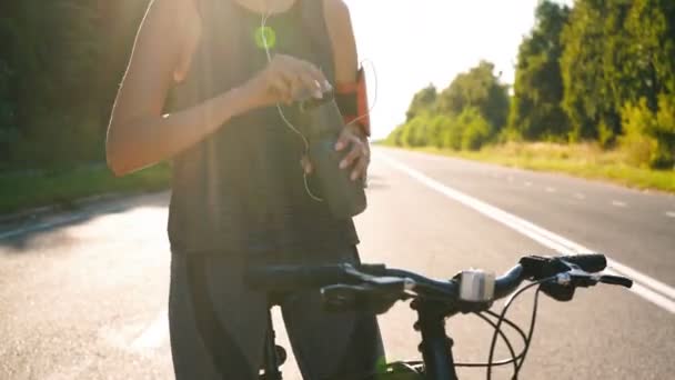 Cyklista holka pije vodu po cvičení — Stock video