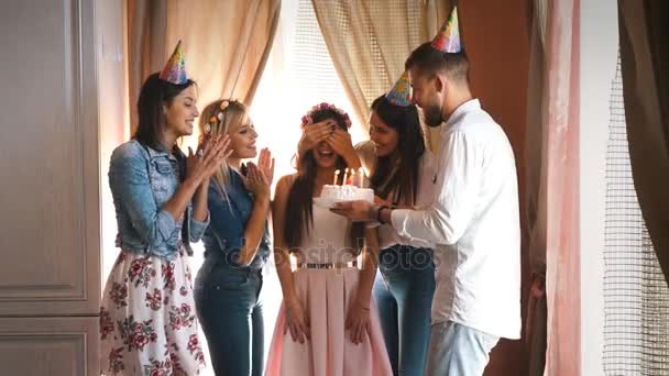Gelukkige verjaardag meisje met vrienden maakt een wens en blaast de kaarsjes op de taart — Stockvideo