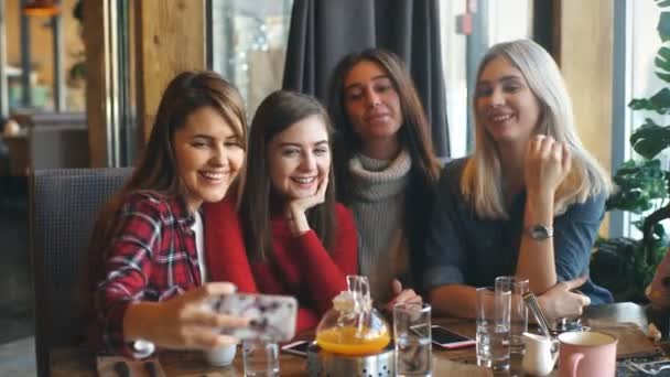 Четыре красивые молодые женщины делают селфи в кафе, лучшие друзья девушки вместе веселятся — стоковое видео