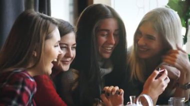 dört arkadaş bakmak telefon ve gülmek