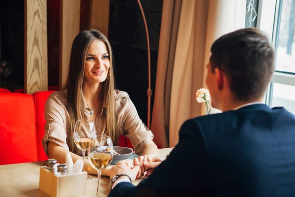 Young happy couple romantic date drink glass of white wine at restaurant, celebrating valentine day — Stock Photo, Image