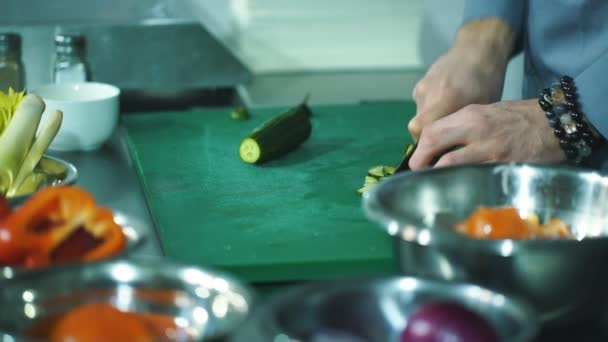 Chef hands with knife cutting vegetables on board — Stock Video