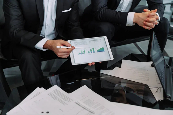 Close up businessman consulting client, holding document with graphs and diagram