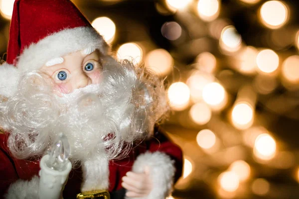 Toy Santa Claus on a background of lights Stock Picture