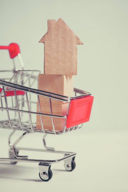 Tramvayda mavi arka planda soyut bir karton ev. Ev satın alma kavramı.