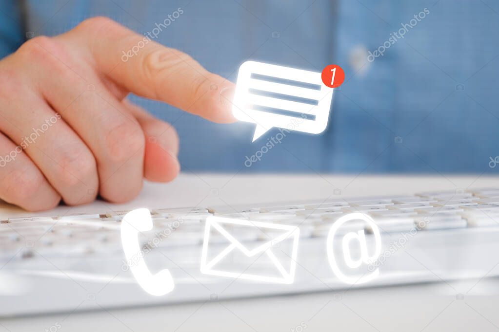 A man in a shirt in front of the keyboard. Abstract phone and notification email icon. The concept of communication through social networks.