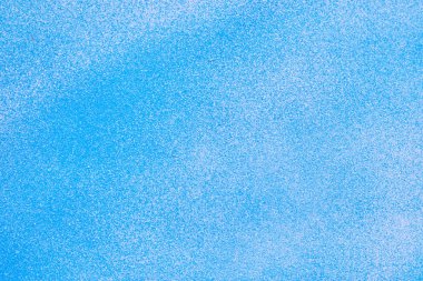 Metallic texture with paint sprayed on it with white and blue.