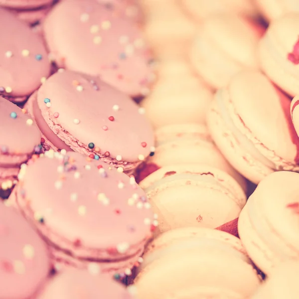 Delicious and beautiful light pink macaroons on sale. square format, toned — Stock Photo, Image