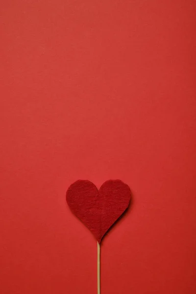 Red heart of fabric on a paper background. Top view. Copy space. — ストック写真