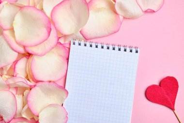 Fotokopi için bir defter arka plan yaprakları üzerinde güller beyaz ve pembe ve kırmızı bir kalp yanında.