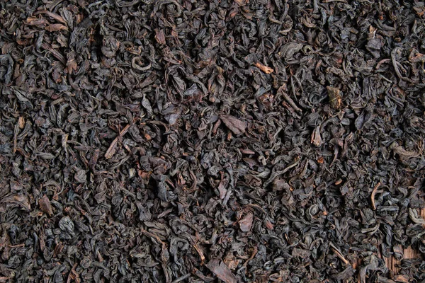 A fekete tea állaga és háttere. Felülnézet. — Stock Fotó