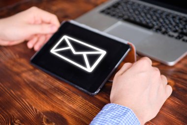 The man works for the tablet and received an email.
