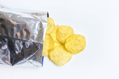 Chips are falling out of foil packaging on a white background.