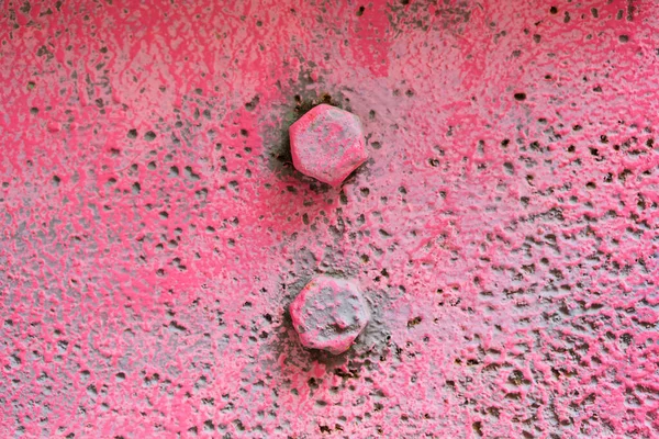 The texture of the metal is pink with bolts. — Stock Photo, Image