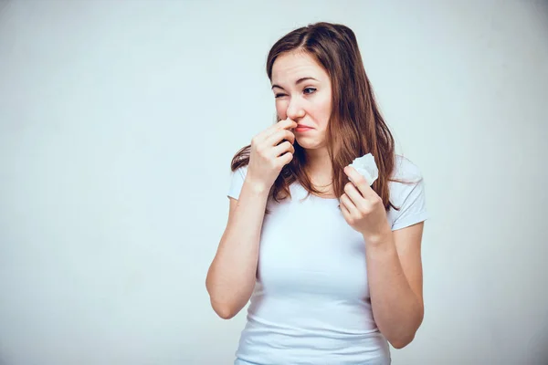 A girl in a white T-shirt is testing different medications for a stuffy nose. Toned. — Stockfoto