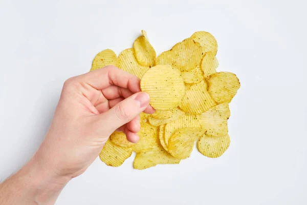 Man holds a chipset with his hand over a set of chips on a white background. — ストック写真