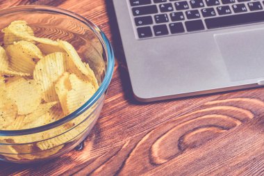 Cam bir kasede, tahta bir masada dizüstü bilgisayarın yanında flüt flüt flütü. Dinlenme kavramı. Ton halinde. Kapat..