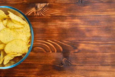 Ahşap zemin üzerinde flüt kırıntıları olan cam bir tabak. Uzayı kopyala Kapatın. Üst görünüm.