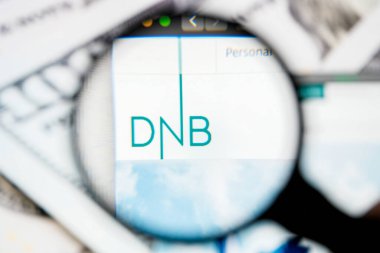 RUSSIA, ST.PETERSBURG - August 12, 2020: DnB ASA logo on the website screen through a magnifier. Close up.
