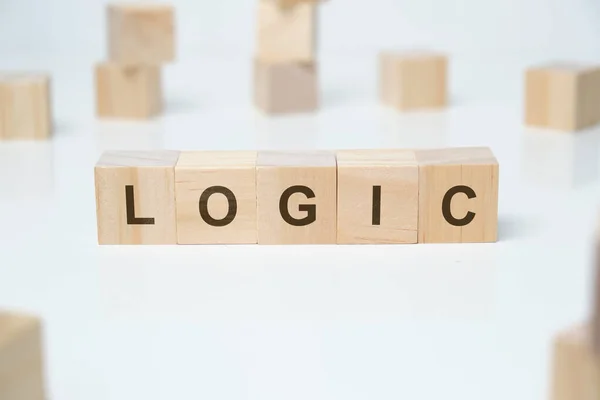 Modern business buzzword - logic. Word on wooden blocks on a white background. Close up.