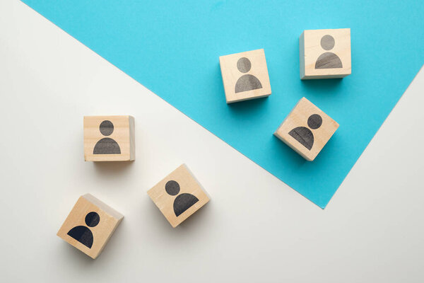 Team competition concept at work with icons on wooden blocks. Close up.