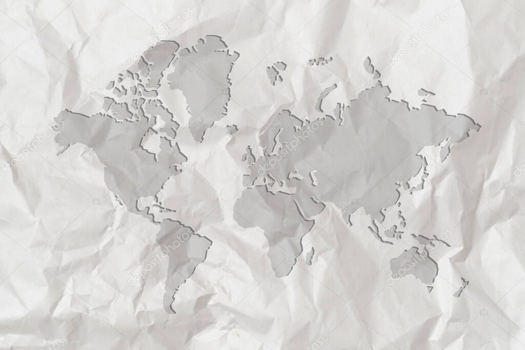 A map of the world is depicted on crumpled white paper. Close up.
