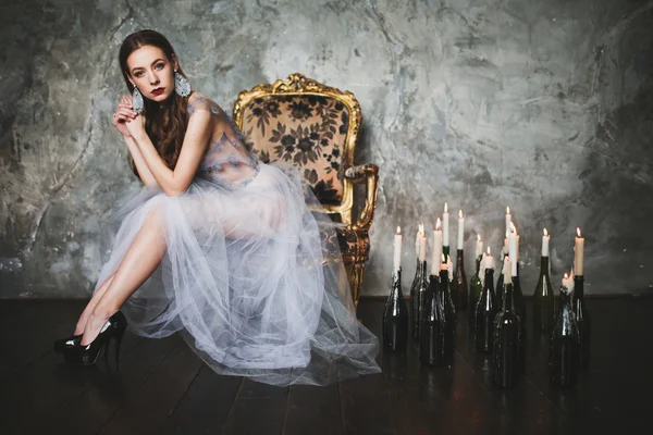 Dark  beautiful princess around candles — Stock Photo, Image