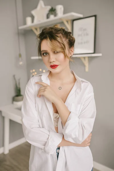 Beautiful young model with red lips and man shirt — Stock Photo, Image