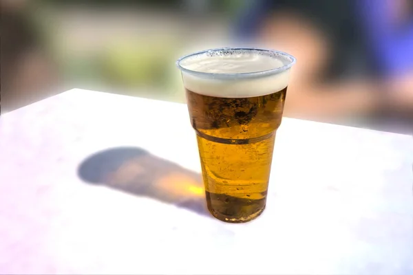 A glass of light beer on a white table — Stock Photo, Image