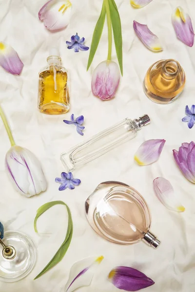 Perfume bottles on silk — Stock Photo, Image