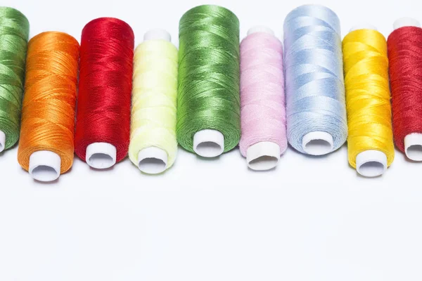 Colorful threads on white — Stock Photo, Image