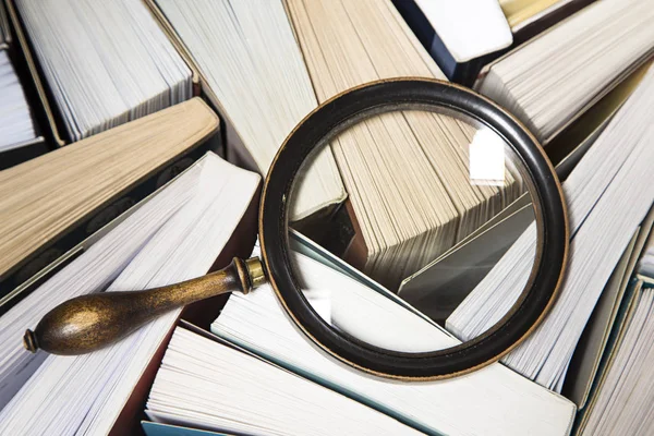 Books and the magnifying glass