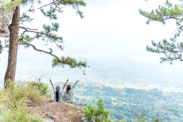 Young happy couple girl spreading hand on top mountain and enjoying forest valley view. — Stock Photo, Image