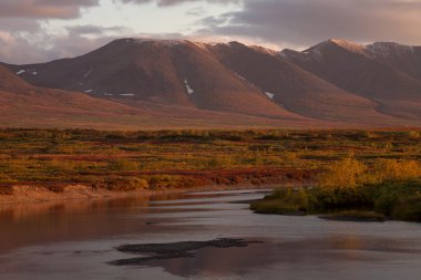 Nehrin karşısındaki sonbahar dağlar.