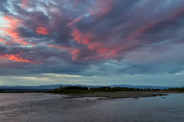 Clouds of red color on a large river. — Stock Photo, Image