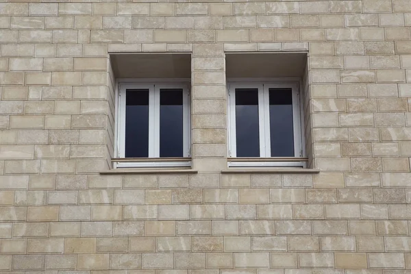 Paired windows in a brick building.