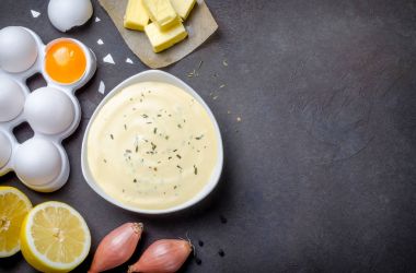 Basic french sauce bearnaise in a white bowl with ingredients, b clipart