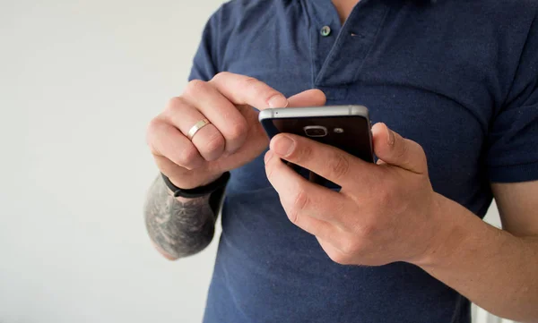 Hipster using a touch screen smart phone hands close up, vintage colors