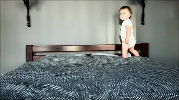 El niño está jugando en la cama — Vídeo de stock